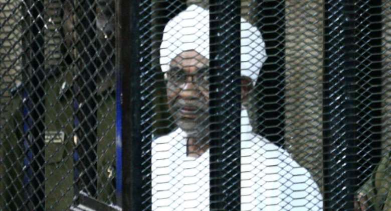 Sudan's traditional government banned two daily newspapers and two satellite channels, along with their parent companies, for allegedly receiving funding from former president Omar al-Bashir pictured during his corruption trial in August 2019.  By Ebrahim HAMID AFPFile