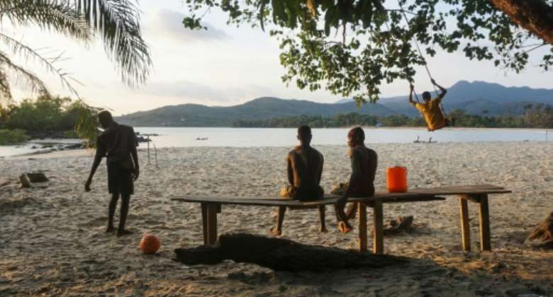 Teenagers on the Black Johnson beach. A tourist attraction 22 miles south of the capital Freetown, Black Johnson village is nestled between stunning black-and-gold beaches and virgin rainforest.  By Saidu BAH AFP