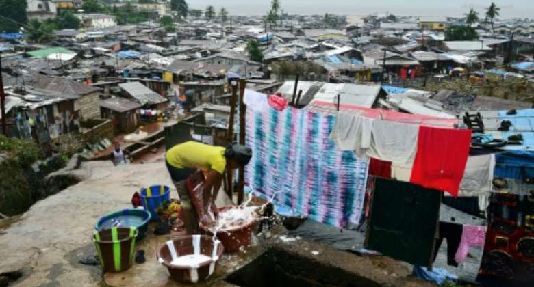 The tin-roofed shacks in Freetown's slums are badly exposed to climate extremes, especially heat.  By CARL DE SOUZA (AFP)