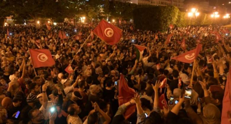 Thousands of Tunisians celebrated Saied's win Sunday.  By Fethi Belaid AFP