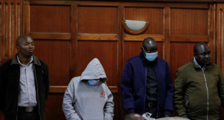 Three officers, including a woman, as well as an informant, were in the dock for sentencing on Friday.  By Tony KARUMBA AFP