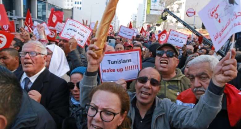 Tunisian opposition supporters take part in a rally against President Kais Saied's power grab and the economic crisis in Tunis on March 13, 2022.  By Anis MILI AFPFile