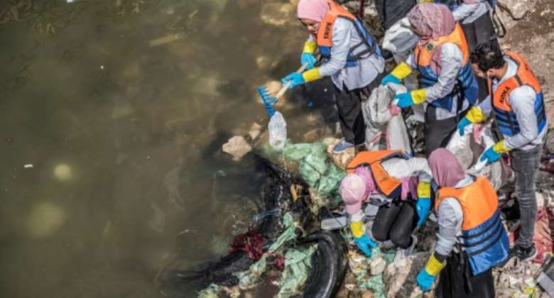 Volunteers collect garbage from the Nile in Egypt's capital Cairo in a clean-up campaign, on March 7, 2020.  By Khaled DESOUKI AFPFile
