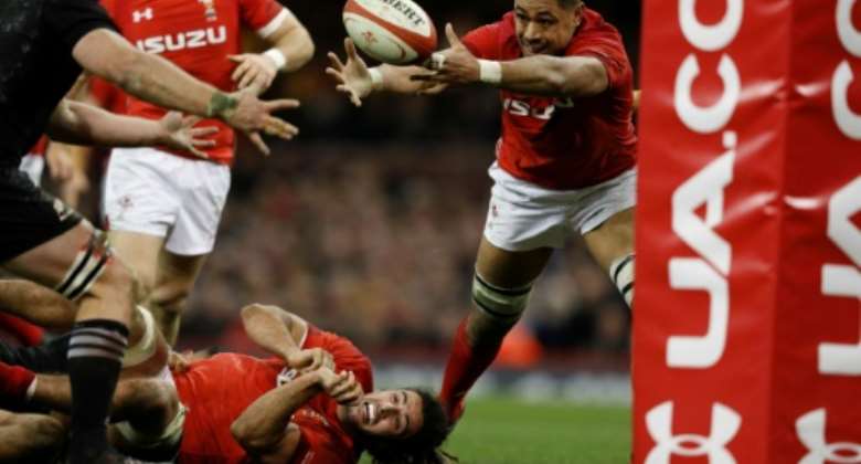 Wales' No. 8 Taulupe Faletau stretches for a loose ball during their rugby union Test match against New Zealand, at the Principality stadium in Cardiff, on November 25, 2017.  By Adrian DENNIS AFPFile