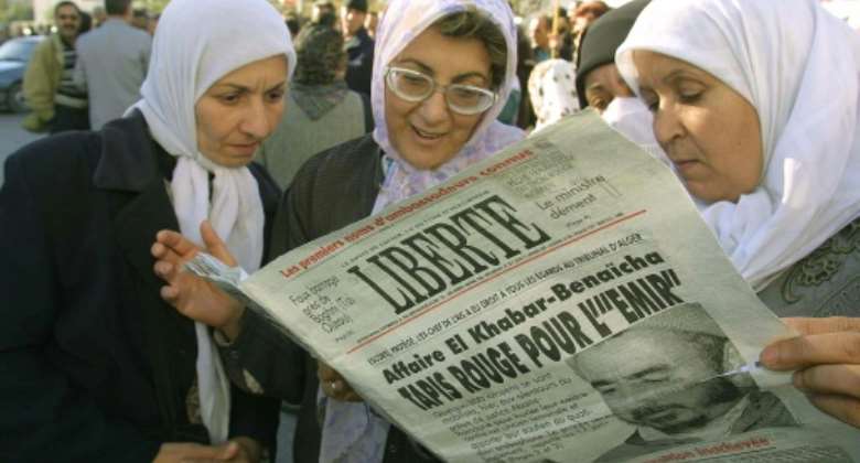 Women in Algiers read the independent Algerian daily Liberte on January 11, 2001 -- the paper called itself a reference for all viewpoints.  By  AFPFile