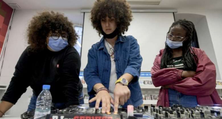 Yasmina Gaida C, known professionally as Fouchika Junior, shows aspiring women DJs the ropes at the French Institute in central Tunis.  By Fethi Belaid AFP