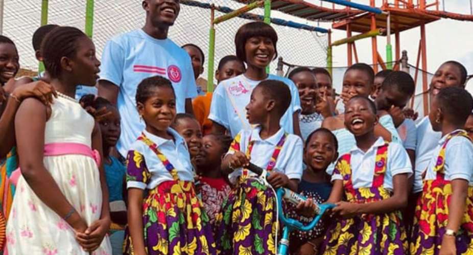 Bright Ofori and Rebecca Kwabi engaging with some children at the event