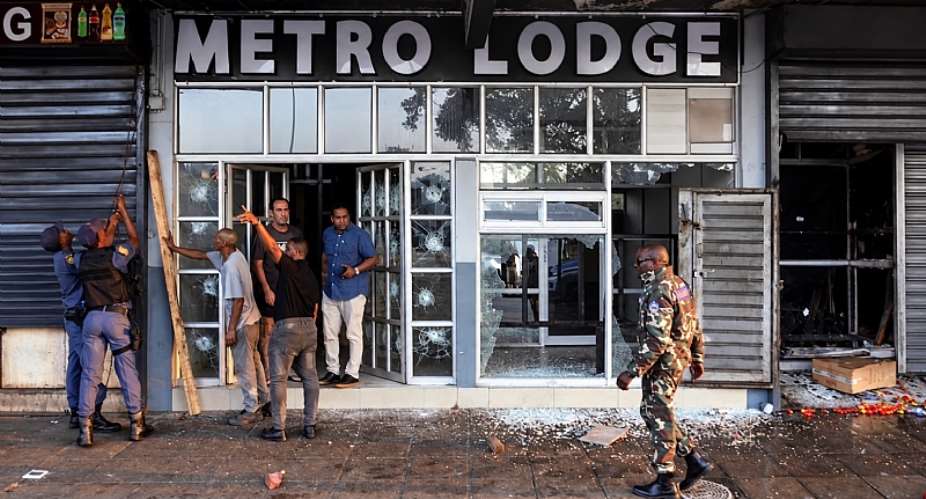 Police examine damage done to a business during anti-immigrant protests in Durban, South Africa, on October 8, 2026. (Photo: Reuters/Rogan Ward)