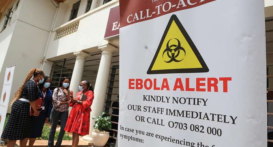 Healthcare professionals outside an isolation centre dedicated to the Ebola virus at a hospital in Nairobi, Kenya, 7 October. -  AP Photo/Andrew Kasuku