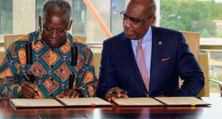 Mr.  Yankah ,left and Dr.  Wilson, right initiating the MOU on behalf of their respective outfits.