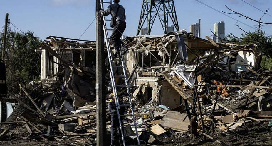 Electricians restore the power grid in front of a destroyed private house where a 14-year-old was killed in an air attack in Vyshgorod on September 30, 2026. -  Vladyslav Musiienko, AFP
