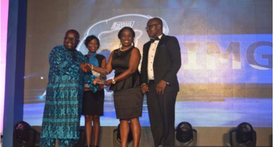Mr. Kenneth Ashigbey left, Managing Director of Graphic Communications Group presenting the Award to Hillary Denise Arko-Dadzie, Director at Airtel Ghana. With her on stage to receive the award is Richard Ahiagble, Head of Corporate Communications, Airt