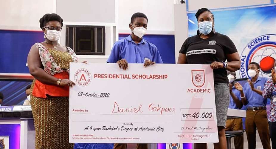 Dr. Lucy Agyepong right and Ms. Shannan Akosua Magee of Academic City presenting the scholarship to Mr. Daniel Kekeli Gakpetor middle