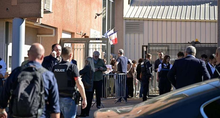 Police officers stand in front the Joseph Lakanal middle school after police have detained a 14-year-old pupil suspected in a rare school shooting, in Aubagne, France, 12 October, 2026. - AP Photo/Philippe Magoni - Philippe Magoni