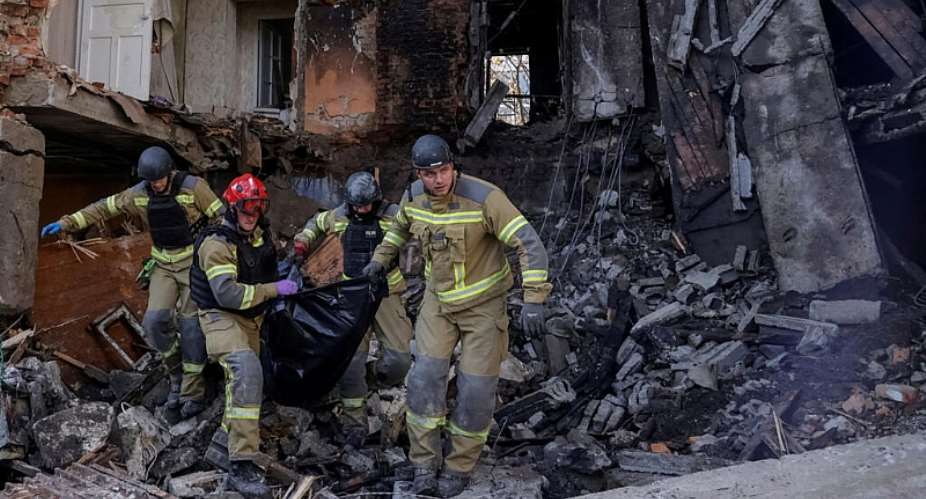 Rescuers carry the body of a person killed in a Russian drone strike on an apartment building in Ukraines Kharkiv, on October 13, 2026. -  Sofiia Gatilova, Reuters