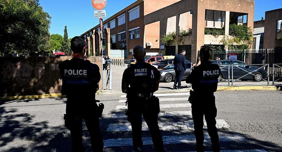 French municipal Police officers patrol outside the Joseph-Lakanal middle school after a headmaster was shot and wounded with a hunting rifle and a teenager was arrested in Aubagne, southern France on October 12, 2026. -  Miguel Medina, AFP