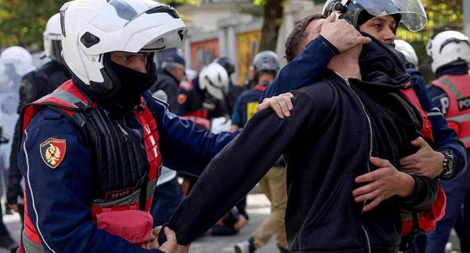 Police detain a protester during an anti-government demonstration in central Tirana on October 15, 2026, as protests continued for a third consecutive day over university conditions and demands for the resignation of Albanian Prime Minister Edi Rama. -  Adnan Beci, AFP