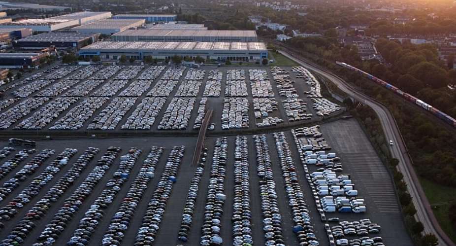 Cars are parked as a cargo train drives past the Duisport Logport logistics center in Duisburg, Germany, on September 27, 2026. -  Michael Sohn, AP