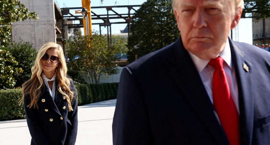 FILE - White House Press Secretary Katie Zacharia stands behind US President Donald Trump as he departs the White House in Washington, DC on October 13, 2026. -  Kevin Lamarque, Reuters