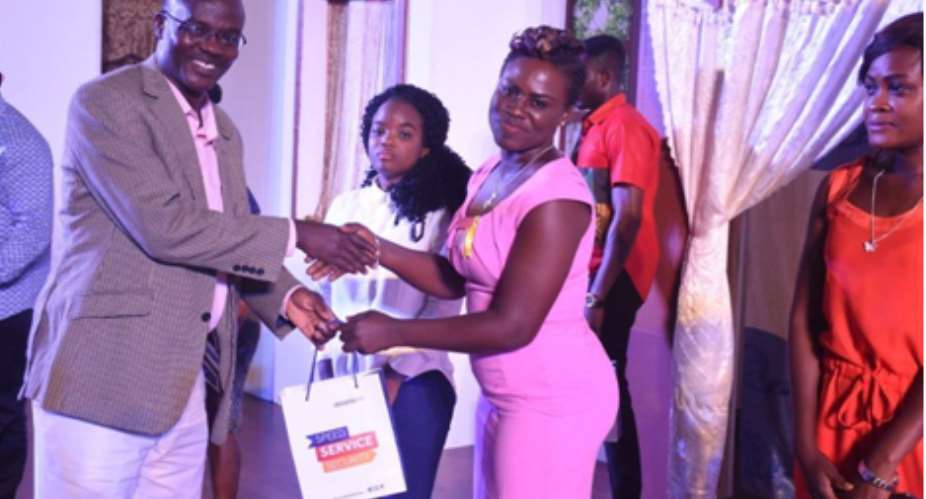 Kameel Adebayo presents prize to a customer