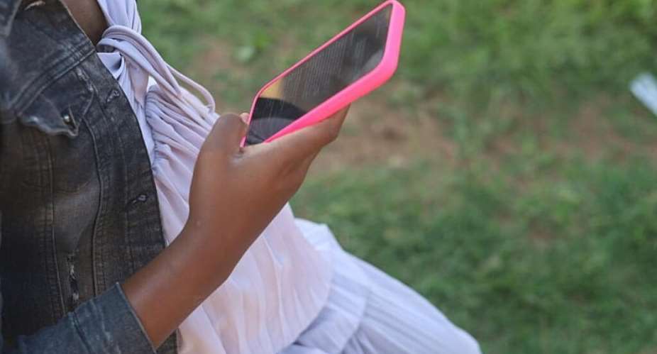 A pregnant woman in Zimbabwe looks at her phone to get pregnancy-related information from a WhatsApp chatbot known as DawaMom. -  Farai Shawn Matiashe