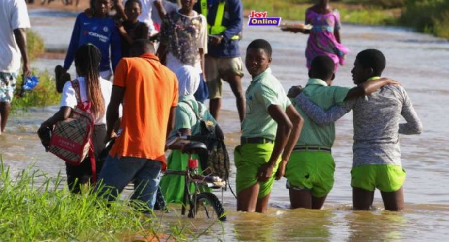 Students Walk In Floods To School At Ngleshie Amanfro Photo