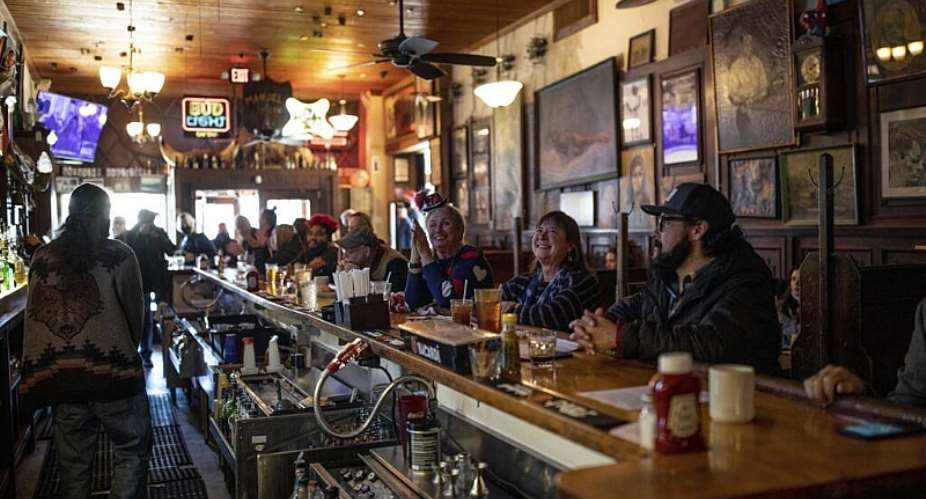 File photo of clients watching Joe Bidens inauguration ceremony on television taken at Manuels Tavern in Atlanta, January 20, 2021. -  Branden Camp, AP