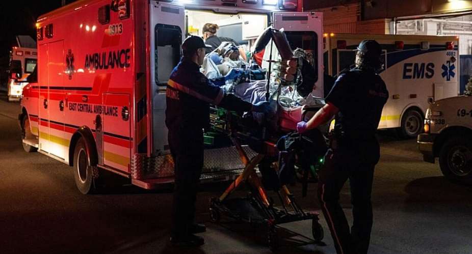 Paramedics load an injured person into an ambulance as injured military members are treated after a fire at Canadian Forces Base,Alberta,  Oct. 17, 2026 -  John Ulan, The Canadian Press