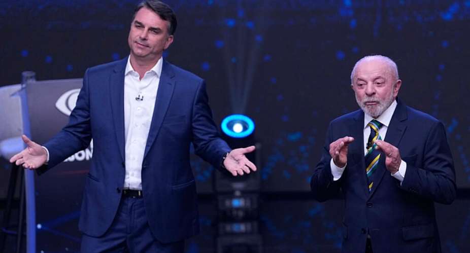 Opposition presidential candidate Senator Flavio Bolsonaro, left, spreads his arms as Brazilian President Luiz Inacio Lula da Silva gestures during a televised presidential debate one week before the presidential runoff election in Sao Paulo, Brazil, Sunday, October 18, 2026. -  Andre Penner, AFP
