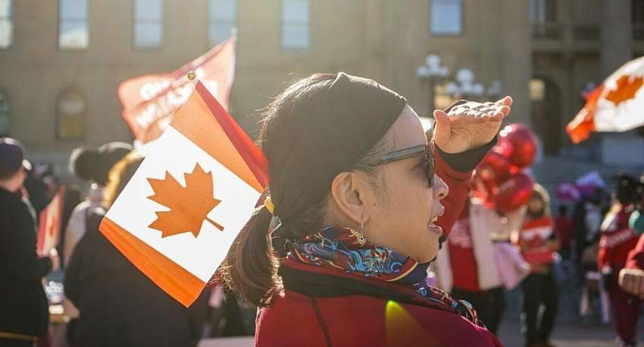 A supporter looks on into a growing crowd during a pro-Canada rally in Edmonton, Alberta, Sunday, 19 October 2026. - Timon Johnson/The Canadian Press - Timon Johnson