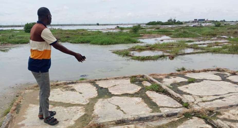 Secretary to the Adina Development Committee, Francis Agbeko stands at the edge of the salt pans
