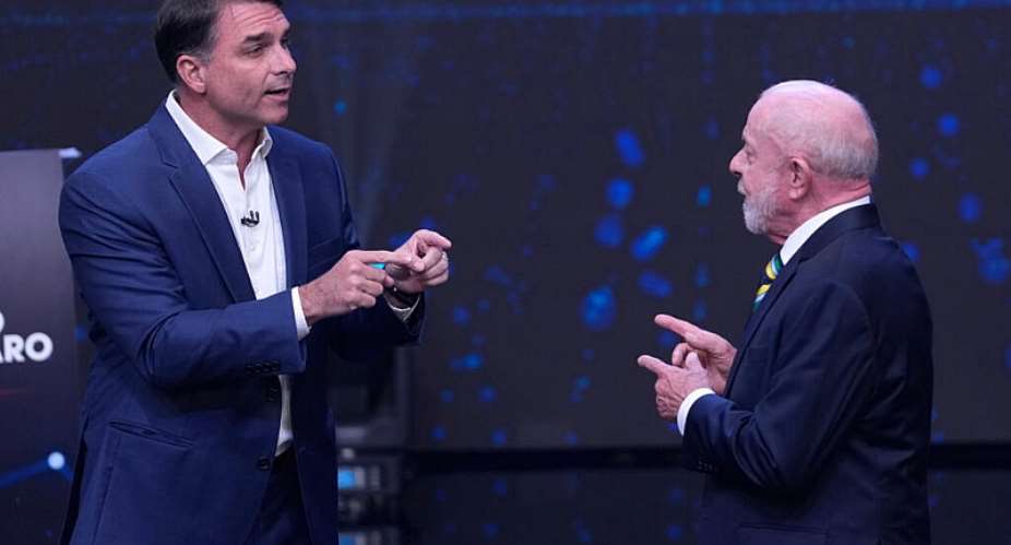 Opposition presidential candidate Senator Flavio Bolsonaro, left, and Brazilian President Luiz Inacio Lula da Silva gesture toward each other during a televised presidential debate one week before the presidential runoff election in Sao Paulo, Brazil, Sunday, October 18, 2026. -  Andre Penner, AP