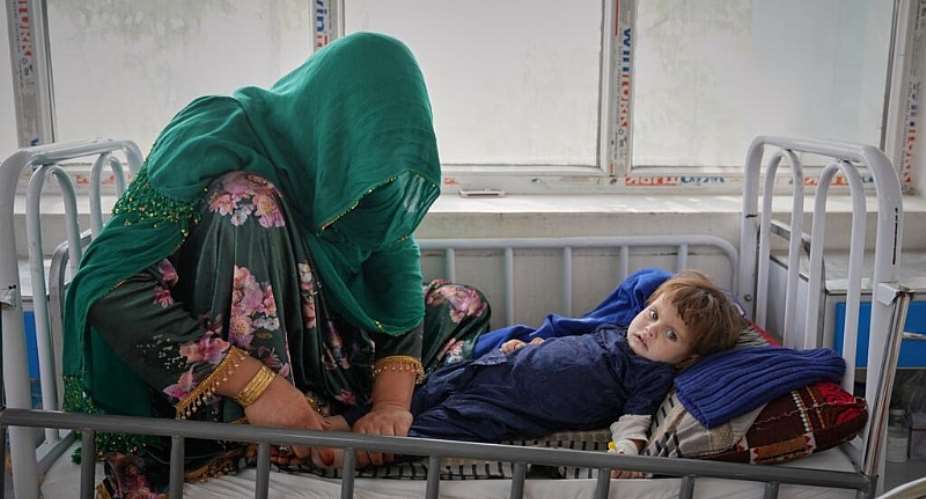 Malika tends to her 3-year-old daughter Kalsoum, who has symptoms of malnutrition, at Indira Gandhi childrens hospital in Kabul, 12 October. -  AP - Siddiqullah Alizai