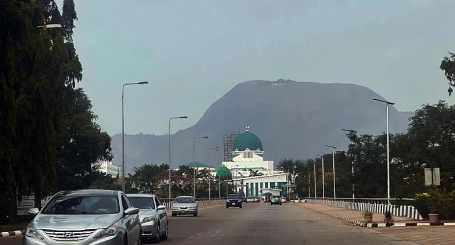 FILE - Cars drive past the National Assembly building in Abuja, Nigeria, on Nov. 2, 2023. -  Chinedu Asadu, AP