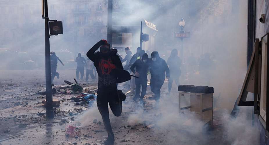 A protester runs on the fringes of a demonstration in Paris on October 17, 2026 which was marred by violent clashes and looting. -  Kiran Ridley, AFP