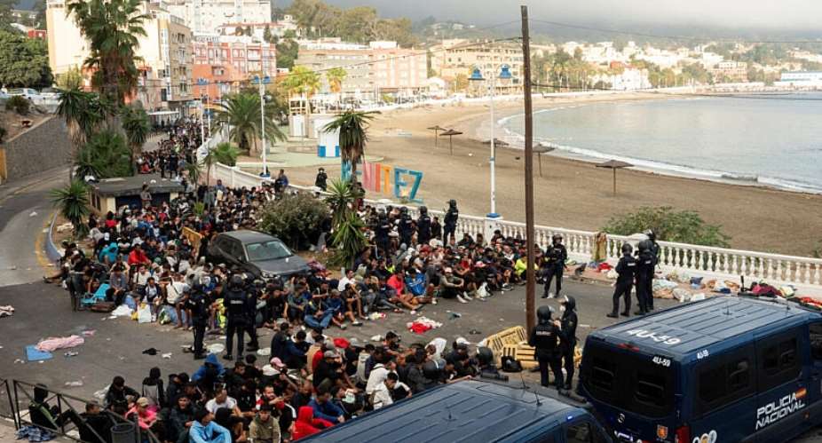 Police escort migrants from Benitez Beach to be relocated to the camp set up at the port of Ceuta, Spain, 18 September 2026. -  REUTERS