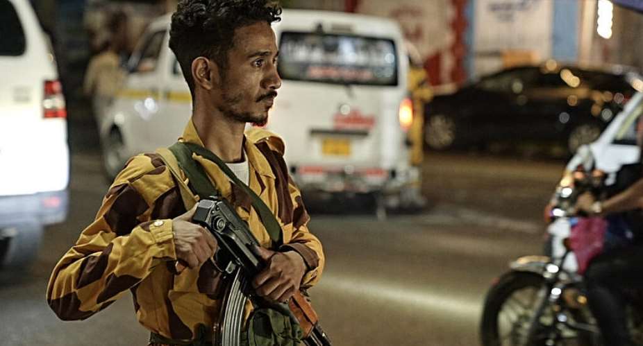 A member of the security forces of the internationally-recognised Yemeni government mans a checkpoint on a street in Taiz -  AFP
