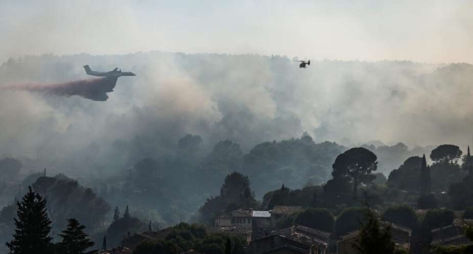 A Bombardier Dash 8 Q400 MR aircraft drops fire retardant over a wildfire near Cotignac in southeastern France on 23 July 2026, during a summer in which record heat stress, drought and extreme temperatures affected much of Europe. - AFP - THIBAUD MORITZ