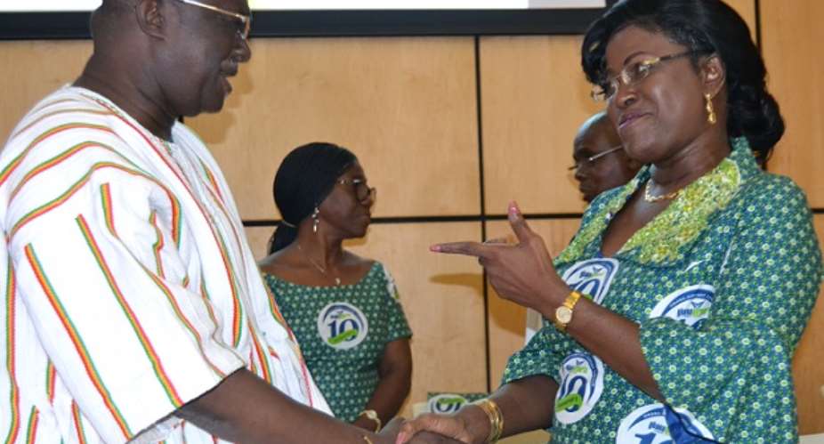 Kofi Adda in a handshake with Oboshie Sai Cofie