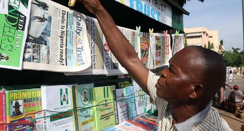 A man displays newspapers carrying headlines about Ebola in Nigeria. The country has confirmed its first case in more than a decade. - AP Photo/Afolabi Sotunde - Afolabi Sotunde
