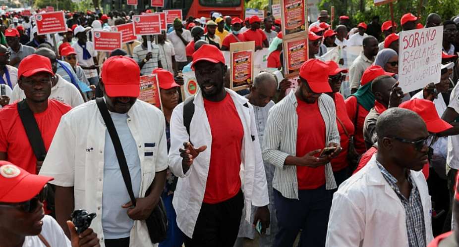 Members of Senegals FSDT union confederation march in Dakar to demand the implementation of labour agreements and reforms to the pension and social security systems. - REUTERS - Misper Apawu