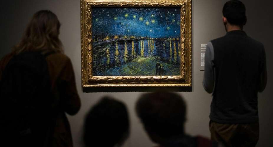 File photo: Visitors look at Vincent Van Goghs painting Starry Night (1888) by Vincent van Gogh during the preview for the upcoming Van Gogh and Britain exhibition at Tate Britain in London on Monday, March 25, 2019. -  Victoria Jones, AP
