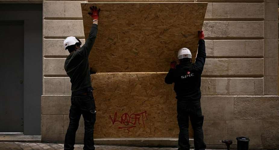Shops in French city centres are boarding their windows ahead of fresh protests planned this weekend, fearing further unrest. -  Philippe Lopez, AFP