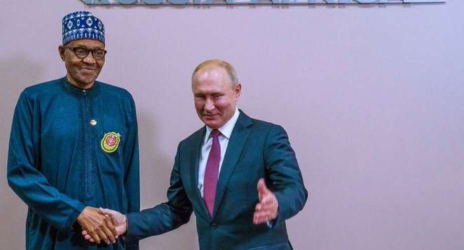 Russia President Vladimir Putin dey shake Nigerian President Muhammadu Buhari hand for di Russia-Africa summit for Sochi. Wednesday October 23, 2019