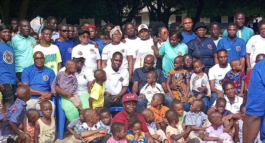 Members EL in pose with some Children