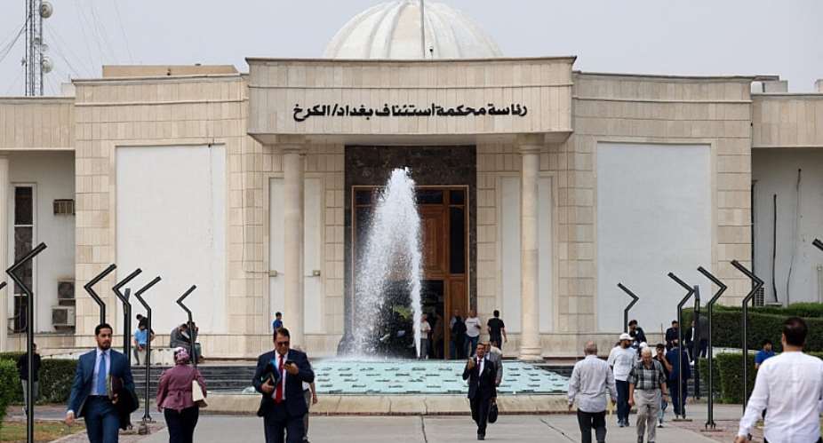 People walk near a court building where six French nationals accused of belonging to Islamic State stood trial, in Baghdad, Iraq, 5 October 2026. -  Ahmed Saad / Reuters