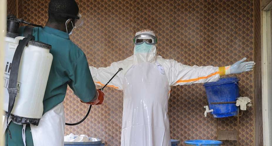 A healthcare worker in protective clothing is disinfected by a colleague inside an Ebola treatment center in Beni, North Kivu province, eastern Congo, September 26, 2026. -  Sebastien Kitsa Musayi, AP