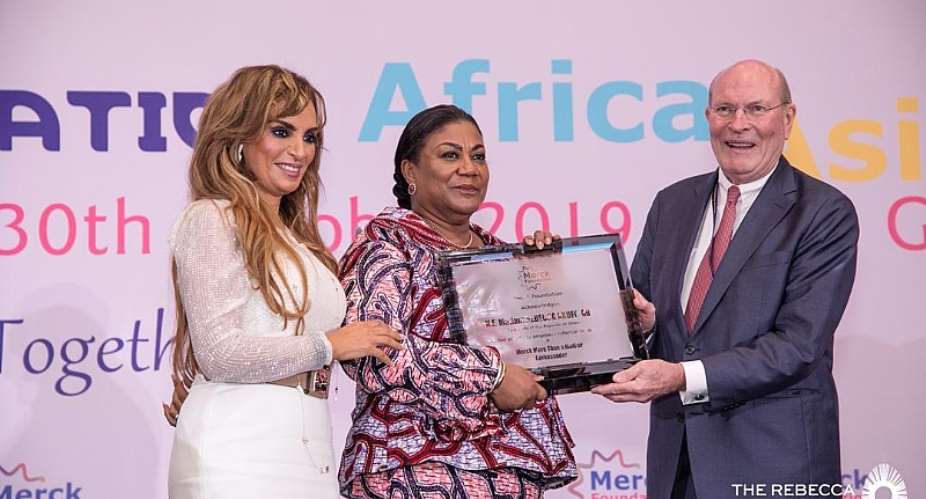 First Lady, Rebecca Akufo-Addo middle receiving an award from prof. Dr. Frank Stangenberg-Haverkamp, chairman of the Board of Trustees of Merck Foundation, with them is CEO Merck Foundation, Dr. Rasha Kelej.