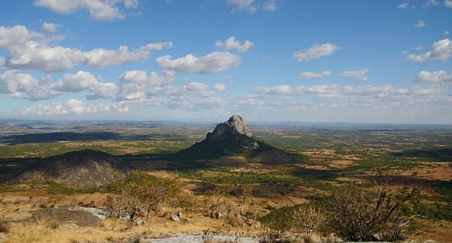 The Hora 1 site is at the base of this peak of rock in northern Malawi. - Source: Chelsea Smith