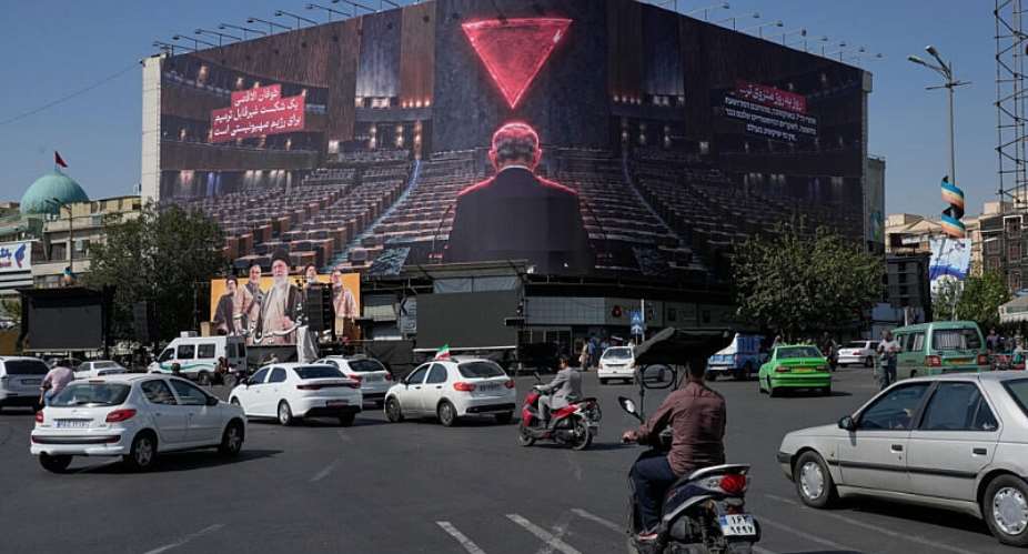 Vehicles drive past a billboard depicting Israeli Prime Minister Benjamin Netanyahu at the Islamic Revolution Square in Tehran on October 12, 2026. -  Vahid Salemi, AP